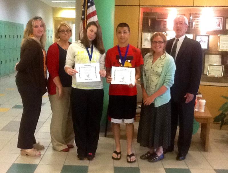 From left to right, Tracie Cote, head of science curriculum at Wareham Middle School, Sandi Ponte, Nobel housemaster, 8th grade students Skylar Martin and Joe Nash, winners of the poetry contest, Beth Giuffrida, science teacher, and Howard Gilmore, Wareham Middle School principal. COURTESY BETH GIUFFRIDA